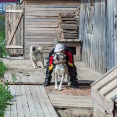 angry dog on a chain. man calms angry chained dog