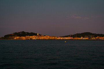 Golden sunset over St. Tropez seen from the sea