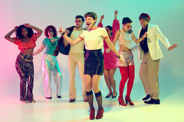 Fototapeta premium Energetic woman leading retro dance group with joyful expression. Concept of music parties, youth culture, lifestyle celebration and creative movement.