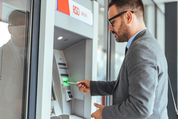 Businessman Using an ATM Machine for Secure Financial Transactions
