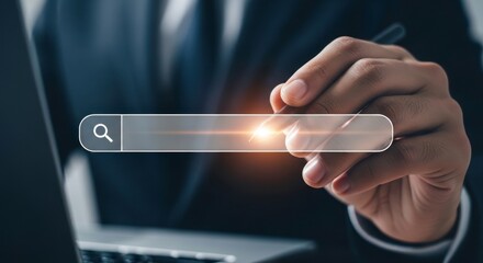 A person holding a search bar with a magnifying glass icon over a laptop screen