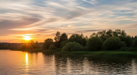 Fototapeta premium A breathtaking sunset over a tranquil river, with golden light reflecting on the water and silhouetted trees along the bank, creating a serene and picturesque natural landscape.