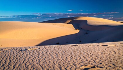 Vast white sand dunes at sunset