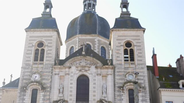 Church facade with clock tower and ornate sculptures in Chalon sur Saone France captured in daylight with architectural details