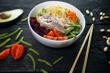 bibimbap with meat in a white plate on a dark background