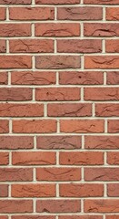 Fototapeta premium Close-up of a rustic red brick wall with textured surface and light mortar, providing a classic background or architectural detail.