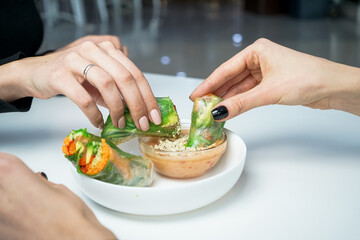 the table is set with Korean food and girls' hands