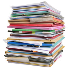 Stacked documents and papers in a disorganized pile often seen in offices or study areas during busy times
