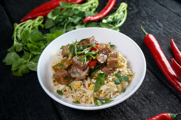 rice with meat and herbs in a white plate