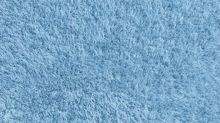 Close-up of soft blue shaggy carpet texture with dense long fibers creating a plush, cozy surface, ideal for interior design, textile samples, home decor and backgrounds.