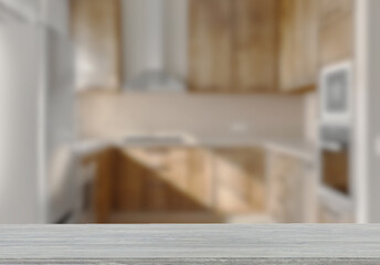 Empty wooden top table with blurred kitchen interior Background. for product display