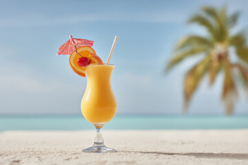 tropical cocktail sits elegantly on pristine beach surrounded by swaying palm trees