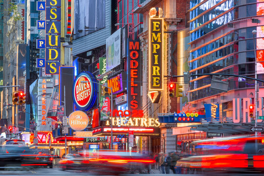NEW YORK CITY - NOVEMBER 14, 2016: Traffic moves below the illuminated signs of 42nd Street. The landmark street is home to numerous theaters, stores, hotels, restaurants, and attractions.