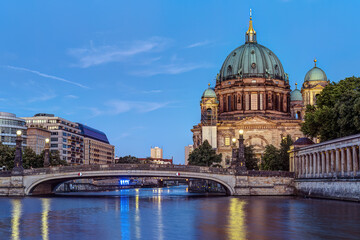 The illuminated Cathedral and the river Spree in Berlin at twilight