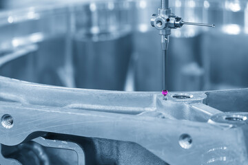 The CMM machine measuring the automotive parts by modular probe in the blue tone. The quality control of automotive parts with CMM machine.
