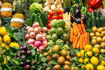 Colorful display of fruits and vegetables at a market stall in Barcelona, Spain