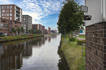 A blue sky with clouds over buildings and the zuid-willemsvaart in Weert the Netherlands