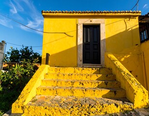Sunny yellow house with steps