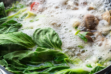 boiling surf clam soup for kalguksu, a Korean noodle soup