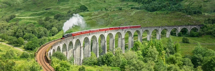 Ingelijste posters Glenfinnanviaduct The Jacobite steam train on Glenfinnan viaduct in North West Highlands, Scotland, UK  © Delphotostock