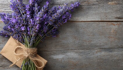 A rustic lavender bouquet tied with twine on wooden background