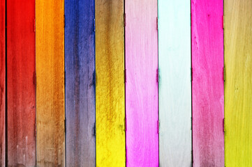 Multi color on wooden plank background.
