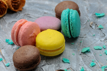 dessert macaroons multi-colored on a gray background macro photo