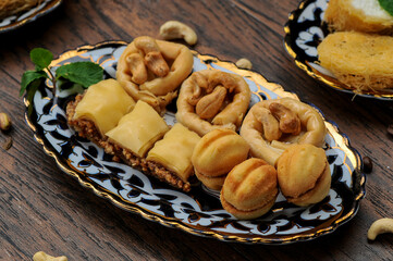 oriental sugar treats in a plate photo on a dark background