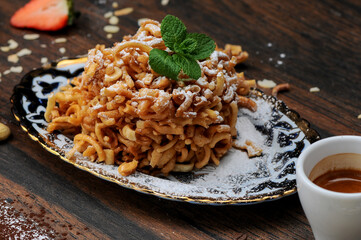 oriental sugar delicacy pie in a plate photo on a dark background macro photo