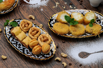 oriental sugar treats in a plate photo on a background with powdered sugar