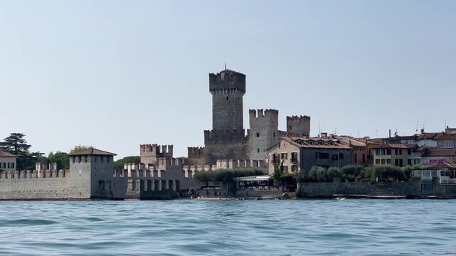 Lake Garda at summer, old town of Sirmione, crystal clear water and beautiful nature