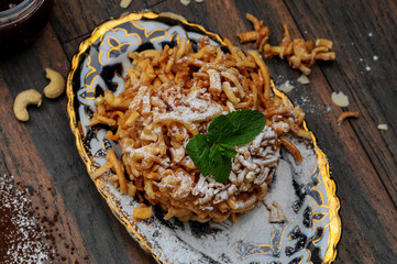 oriental sugar delicacy pie in a plate photo on a dark wood background