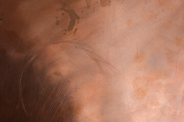 The scratched and stained copper surface is dark in the lower left corner. Copper oxidation. Space for design.