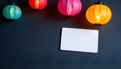 Illuminated lanterns with blank card: Four vibrant lanterns illuminate a dark, textured backdrop, a blank card beneath suggests space for personalization.