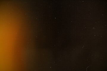 light leak overlay effect with scratch dust and moion blur orange light leaks,retro film burn distressed grain noisy texture light leak flare on black background,old film texture