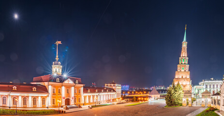 Fototapeta premium The ancient leaning red brick Syuyumbike Tower at night on the territory of the Kazan Kremlin. Russia