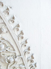 Thai temple stucco art on the white wall.