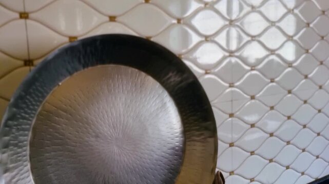 This large metal "Parat" is an essential Indian kitchen utensil, typically used by women to knead dough for bhakri and other flatbreads, placed conveniently above the sink, ideal design for dough prep