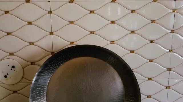 The "Parat," a broad metal plate, is a vital Indian kitchen tool, particularly for women kneading dough for bhakri & other flatbreads. Its design is perfect for dough work, kept handily by the sink.