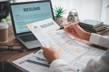 Naklejka premium People are reviewing job applications before filling out their resume on the job application form in order to apply for a job at a company.