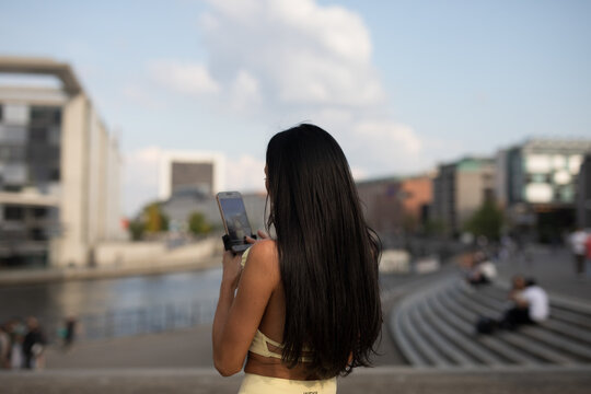 young woman walking along the street