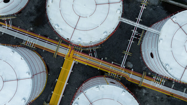Aerial view white oil storage tank with pipeline steel, Crude oil industry, Storage fuel gas container tank petroleum refinery industrial factory, Oil storage chemical petrochemical refinery product. - Powered by Adobe