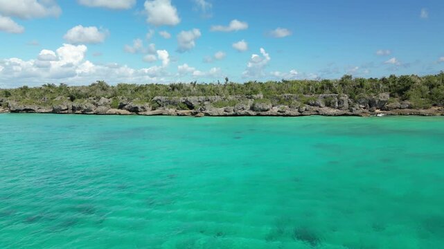 4K aerial of El Penon &mdash; turquoise Caribbean waters and rugged cliffs with cinematic views