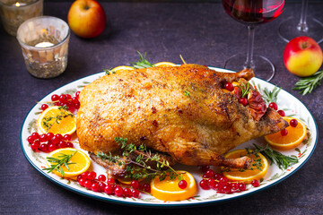 Roasted whole duck with fuits and berries served on oval side dish plate