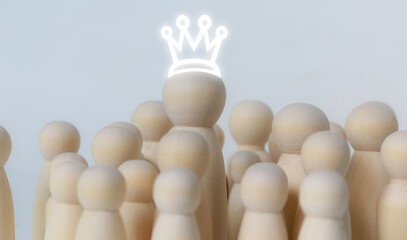 A white crown is worn on a wooden figure among a group of smaller wooden figures surrounding it