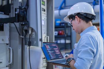 Electrical engineer male checking voltage at the Power Distribution Cabinet in the control room,preventive maintenance Yearly,inspecting power system and control panel in industrial factory