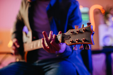 Musician composing music at home studio playing electric guitar
