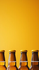 Row of chilled amber beer bottles with golden caps and condensation against a bright orange background, leaving ample copy space above.