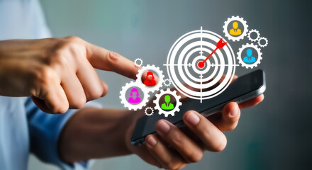 Person using a smartphone with a digital overlay of gears, a target, and people icons, representing strategy and teamwork in business