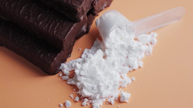 Vanilla protein powder in scoop and protein bars. Dietary supplement, nutrition, healthy energy snack. High quality 4k footage